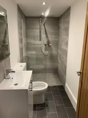 a bathroom with a shower and a toilet and a sink at Newly renovated 4 bedroom house in Ulverston in Ulverston