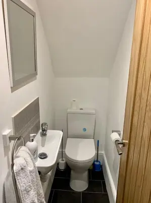 a small bathroom with a toilet and a sink at Newly renovated 4 bedroom house in Ulverston in Ulverston