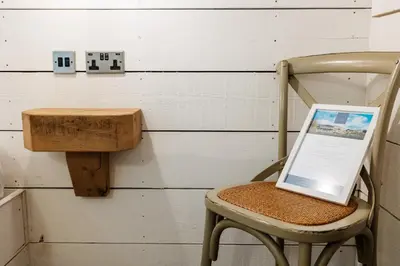 a laptop sitting on a chair in a room at Bashall Barn in Clitheroe