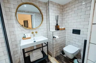 a bathroom with a sink and a mirror at Bashall Barn in Clitheroe