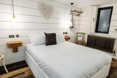 a white bed in a room with white walls at Bashall Barn in Clitheroe