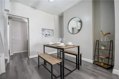 a dining room with a table and a mirror at Stay with Alexandra - Free Parking - Free Wifi Superb Location in Liverpool