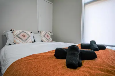 a bed with black stuffed animals laying on it at Stay with Alexandra - Free Parking - Free Wifi Superb Location in Liverpool