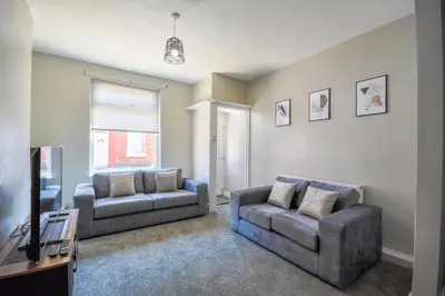 a living room with two couches and a tv at Stay with Alexandra - Free Parking - Free Wifi Superb Location in Liverpool