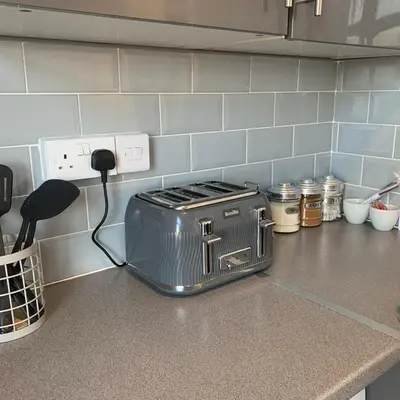 a toaster sitting on top of a kitchen counter at The WhiteHouse Holiday Apartments in Blackpool