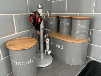 a group of tin cans on a shelf in a kitchen at The WhiteHouse Holiday Apartments in Blackpool