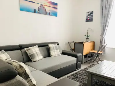 a living room with a couch and a table at The WhiteHouse Holiday Apartments in Blackpool