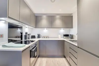 a kitchen with white cabinets and stainless steel appliances at 35 percent Off Stylish Liverpool Abode in Liverpool