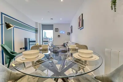 a dining room with a glass table and chairs at 35 percent Off Stylish Liverpool Abode in Liverpool