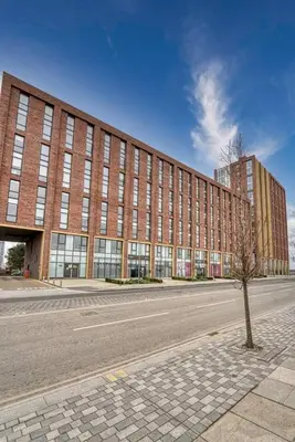 a large brick building with a tree in front of it at 35 percent Off Stylish Liverpool Abode in Liverpool