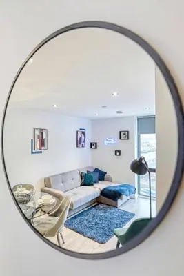 a living room with a couch and a mirror at 35 percent Off Stylish Liverpool Abode in Liverpool