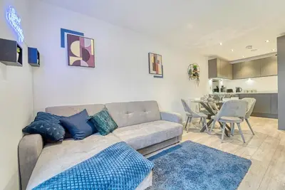 a living room with a couch and a dining room at 35 percent Off Stylish Liverpool Abode in Liverpool