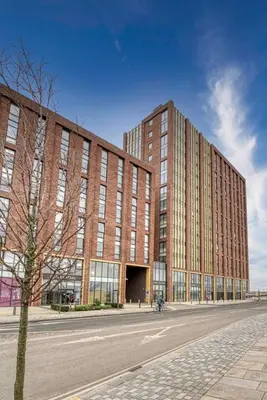 a large brick building on a street next to a road at 35 percent Off Stylish Liverpool Abode in Liverpool
