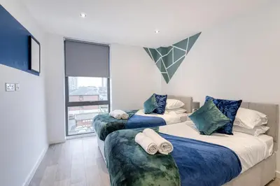two beds in a room with a window at 35 percent Off Stylish Liverpool Abode in Liverpool
