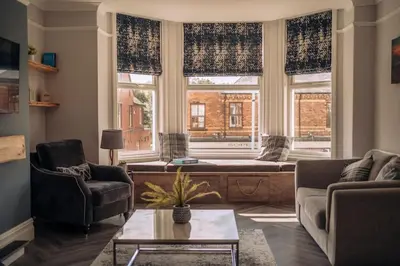 a living room with a couch and chairs and a window at The Dunes, Lytham St Annes in Lytham St Annes