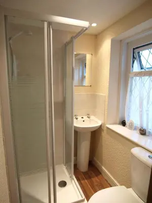 a bathroom with a shower and a sink at Phillips Apartments in Blackpool
