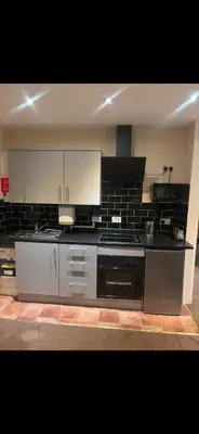 a large kitchen with a stove top oven in it at Phillips Apartments in Blackpool
