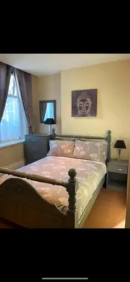 a bedroom with a bed with a skull on the wall at Phillips Apartments in Blackpool