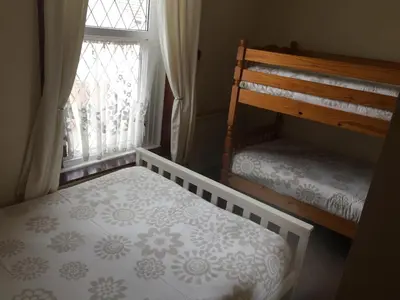 a bedroom with two bunk beds and a window at Phillips Apartments in Blackpool