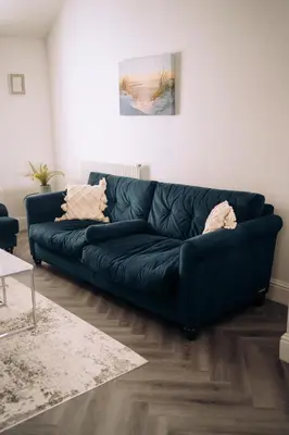 a blue couch sitting in a living room at The Windmill, Lytham St Annes in Saint Annes on the Sea