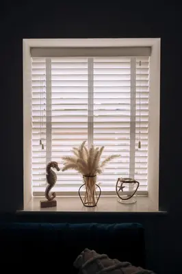 a window with a vase and a snake on a window sill at The Windmill, Lytham St Annes in Saint Annes on the Sea