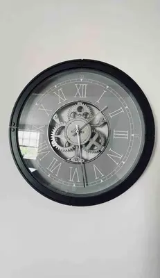 a clock on a white wall with a clock on it at The Windmill, Lytham St Annes in Saint Annes on the Sea