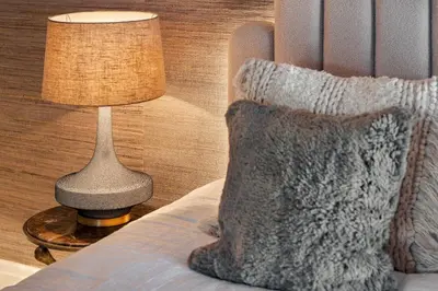 a lamp sitting on a table next to a bed at Wharton House Mews in Cartmel, Lake District - Ridgestone in Cartmel