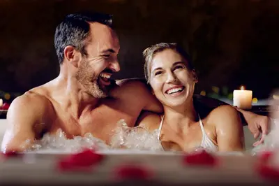 a man and a woman sitting in a bathtub at Wharton House Mews in Cartmel, Lake District - Ridgestone in Cartmel