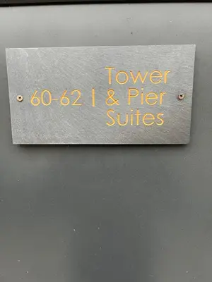 a sign that says tower i and pier suites at The Pier Suite Serviced Apartment Blackpool in Blackpool