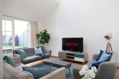 a living room with two couches and a tv at Weekly & Monthly stays in Penthouse for Contractors or Leisure Single or Superking beds available in Birkenhead