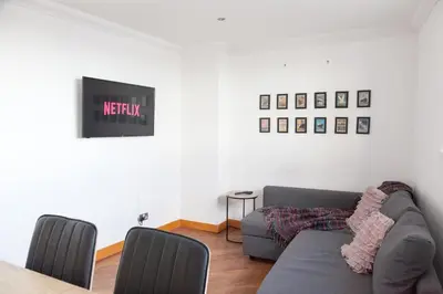 a living room with a couch and a table at Weekly & Monthly stays in Penthouse for Contractors or Leisure Single or Superking beds available in Birkenhead