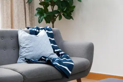 a blue and white blanket sitting on a couch at Weekly & Monthly stays in Penthouse for Contractors or Leisure Single or Superking beds available in Birkenhead