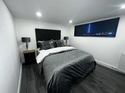 a bedroom with a large bed in a room at New osborne hot tub and jacuzzi suites in Blackpool