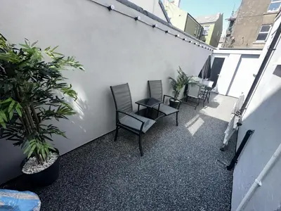 a balcony with chairs and plants on a building at New osborne hot tub and jacuzzi suites in Blackpool