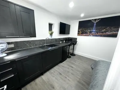 a kitchen with black cabinets and a sink at New osborne hot tub and jacuzzi suites in Blackpool