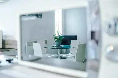 a reflection of a table and chairs in a mirror at 1BR & 2BR Apt -for CONTRACTORS- free PARKING close to EVERTON & ANFIELD stadium, Liverpool City Centre managed by Chique Properties Ltd in Liverpool