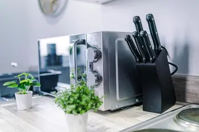a kitchen counter with a knife block on a counter at 1BR & 2BR Apt -for CONTRACTORS- free PARKING close to EVERTON & ANFIELD stadium, Liverpool City Centre managed by Chique Properties Ltd in Liverpool