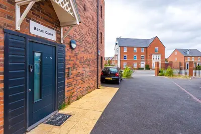 a building with a blue door on the side of a street at 1BR & 2BR Apt -for CONTRACTORS- free PARKING close to EVERTON & ANFIELD stadium, Liverpool City Centre managed by Chique Properties Ltd in Liverpool
