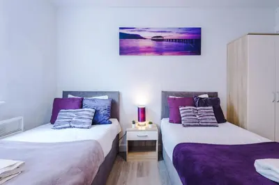 two beds sitting next to each other in a room at 1BR & 2BR Apt -for CONTRACTORS- free PARKING close to EVERTON & ANFIELD stadium, Liverpool City Centre managed by Chique Properties Ltd in Liverpool