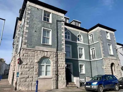 a blue car parked in front of a building at Stunning 3 Bedroom Penthouse in Ulverston Center in Ulverston