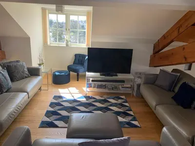 a living room with a couch and a flat screen tv at Stunning 3 Bedroom Penthouse in Ulverston Center in Ulverston