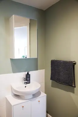 a bathroom with a white sink and a mirror at City Centre short & long stay apartment in Liverpool