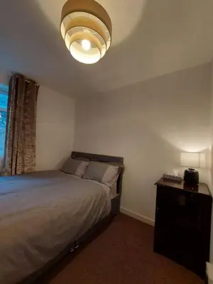 a bedroom with a large bed and a lamp at Liverpool Newington Stay in Liverpool
