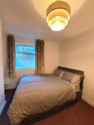 a bedroom with a bed and a large window at Liverpool Newington Stay in Liverpool