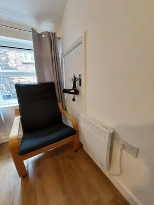 a black chair in a room with a window at Liverpool Newington Stay in Liverpool