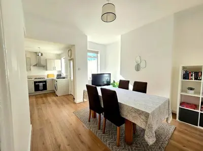 a kitchen and dining room with a table and chairs at Entire house, Waterloo, free street parking in Waterloo