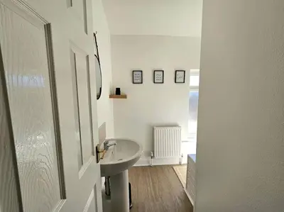 a white bathroom with a sink and a mirror at Entire house, Waterloo, free street parking in Waterloo
