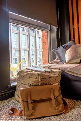 a brown bag sitting on the floor next to a window at One of Kind Boutique Pad in Liverpool