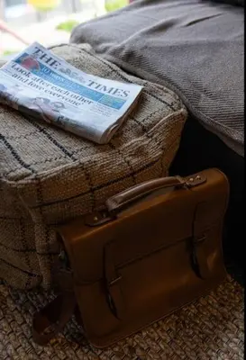 a book and a suitcase sitting on top of a bed at One of Kind Boutique Pad in Liverpool