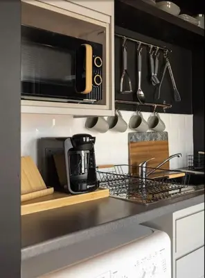 a kitchen counter with a coffee maker and a microwave at One of Kind Boutique Pad in Liverpool